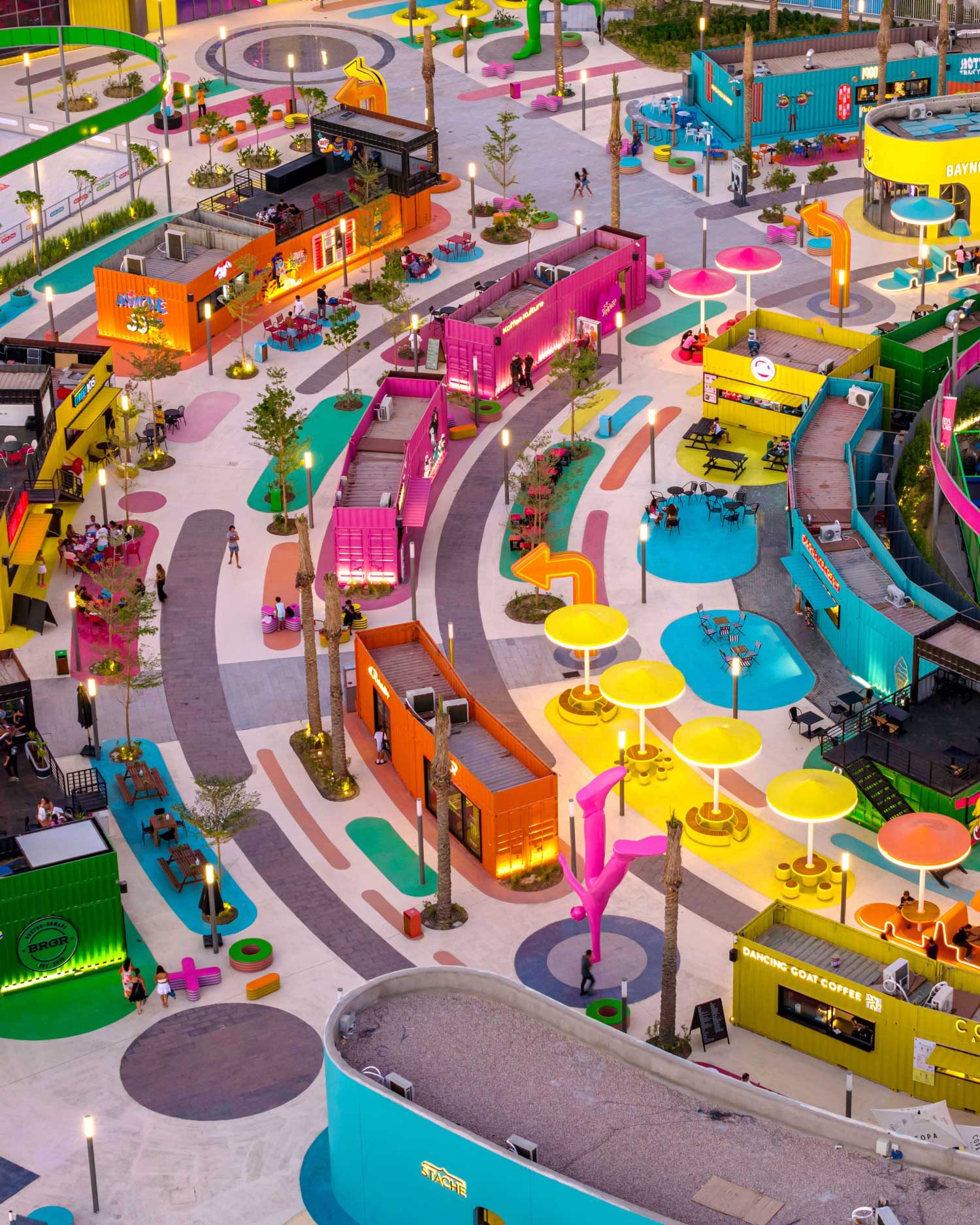 Aerial view of The Hub showing its circular plazas, coloured ground graphics and surrounding programme.